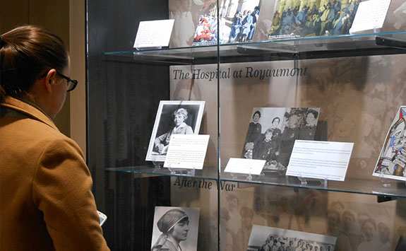 A woman looking through exhibition cabinets